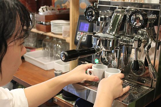 2 demitasse cups set side by side under the spouts of the espresso machine